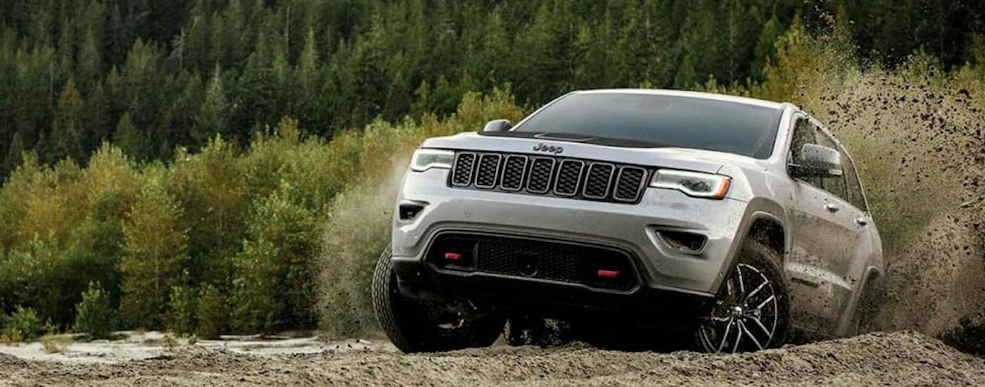 A grey 2019 Jeep Grand Cherokee Trailhawk is shown off-roading.