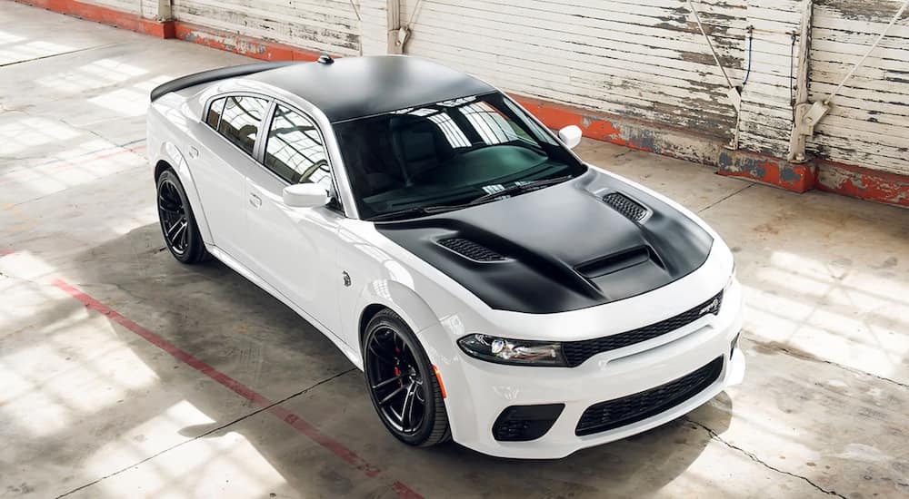 A white 2022 Dodge Charger SRT Hellcat Redeye Widebody parked in a garage.