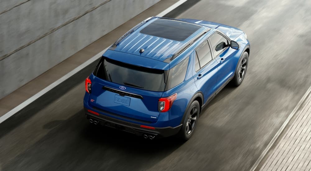 Overhead view of a blue 2020 Ford Explorer ST driving on a highway ramp.
