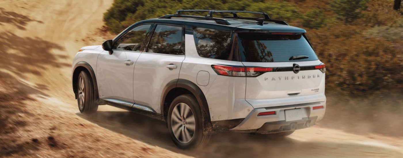 A white 2023 Nissan Pathfinder is shown from the rear at an angle.