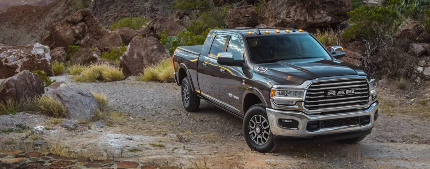 A grey 2022 Ram 1500 Limited Longhorn is shown parked on a gravel path.