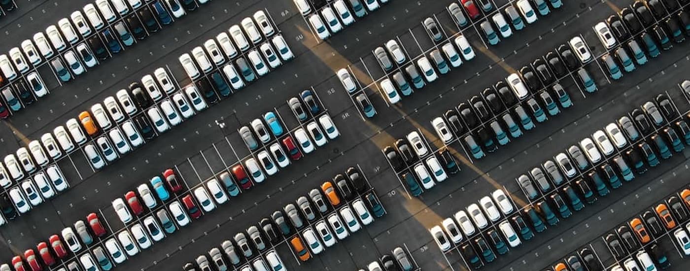 A large lot full of certified pre-owned cars is shown from a high view.