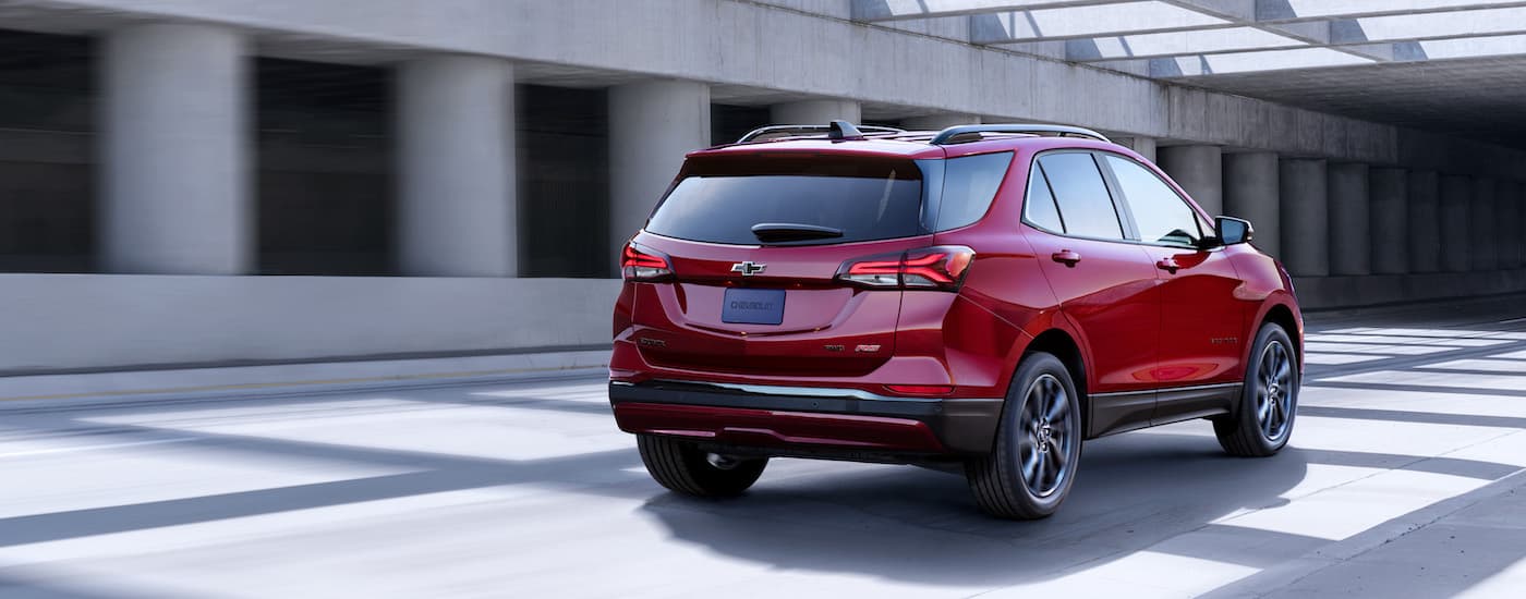 A red 2022 Chevy Equinox RS is shown from the rear at an angle.