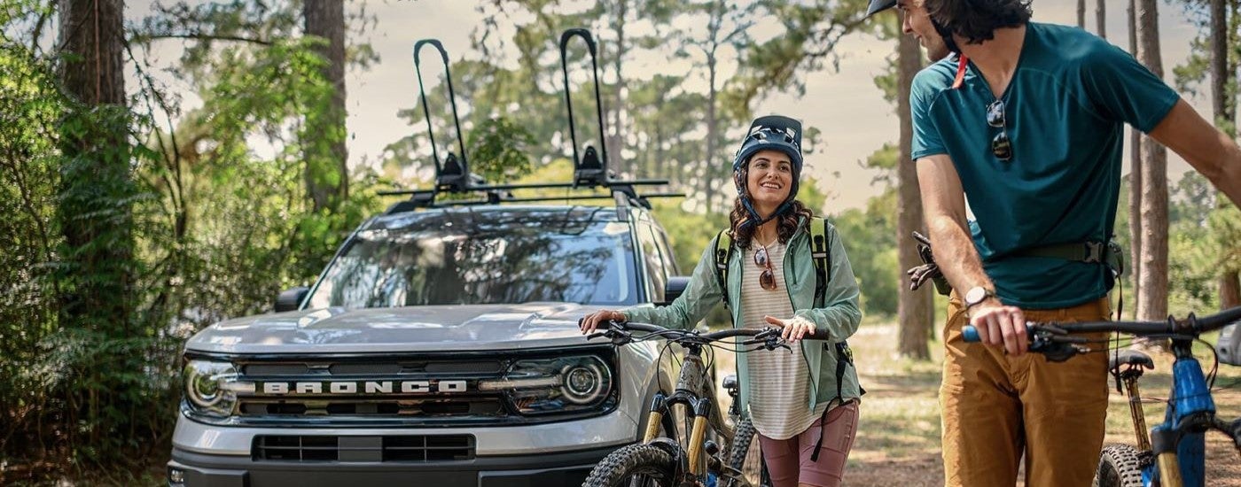 A silver 2021 Ford Bronco Sport Outer Banks is shown near a bike path.