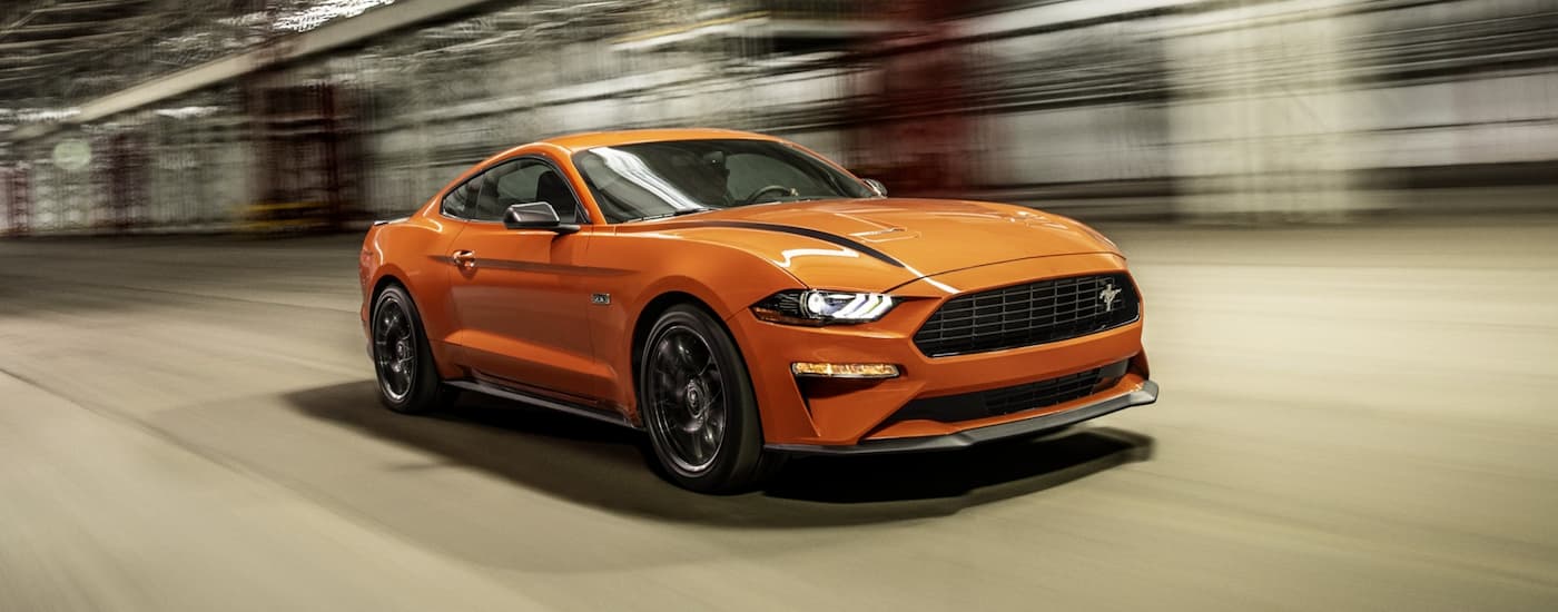 An orange 2021 Ford Mustang EcoBoost HPP is shown from the front at an angle.
